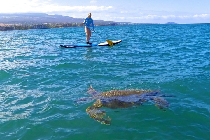 a man riding a surf board on a body of water