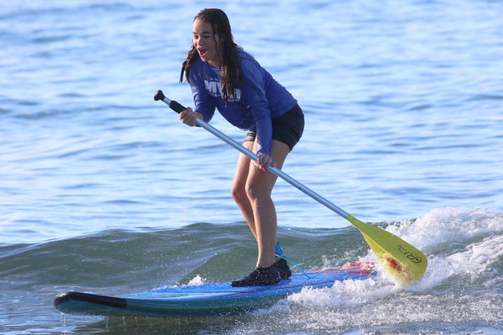 a person riding a surf board on a body of water